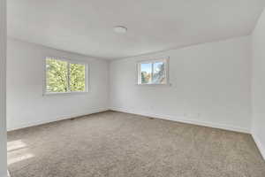 Spare room with carpet floors and baseboards