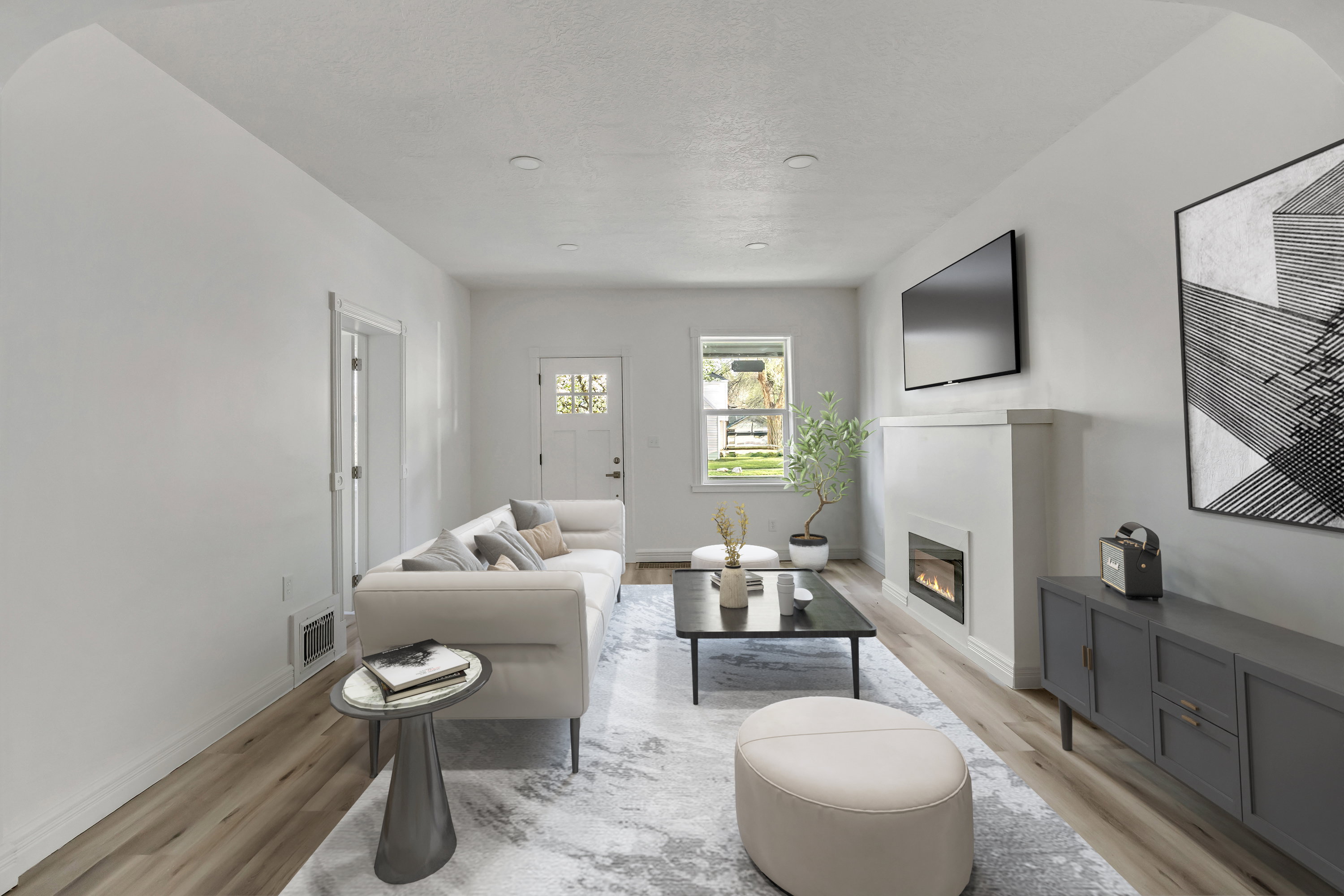 Living area with wood finished floors and a glass covered fireplace