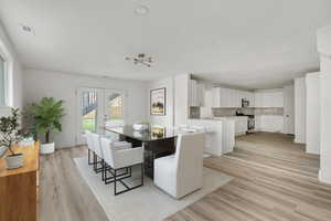 Dining space with french doors, light wood finished floors, and recessed lighting
