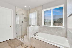 Stone flooring within and around the tub and shower