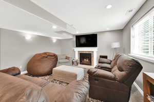Living room in basement with fireplace
