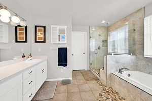 Master bathroom with updated counters, tile, soaking tub and shower