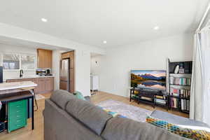 Living area featuring light wood-type flooring and recessed lighting