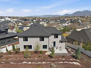 Back of house with a patio area, a fenced backyard, a residential view, and a shingled roof