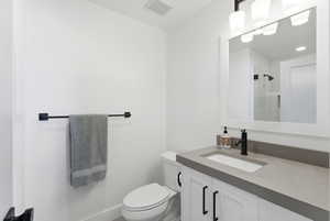Bathroom featuring vanity and a shower