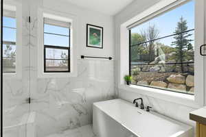 Primary Bathroom featuring a freestanding bath