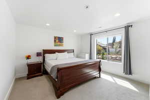 Bedroom featuring recessed lighting and light carpet