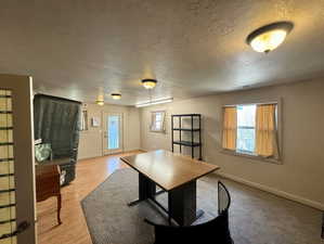 Office area with a textured ceiling and baseboards