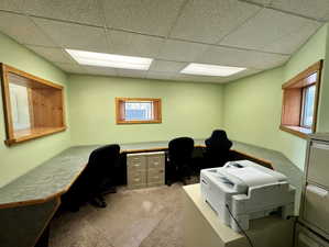 Office area featuring a paneled ceiling