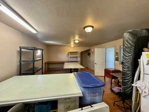 Office space featuring dark wood-type flooring and a textured ceiling