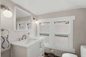 Half bathroom featuring toilet and vanity