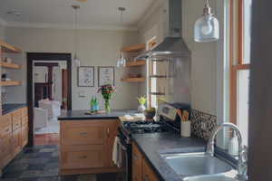 Kitchen with open shelves, dark countertops, stainless steel gas range, ornamental molding, and pendant lighting