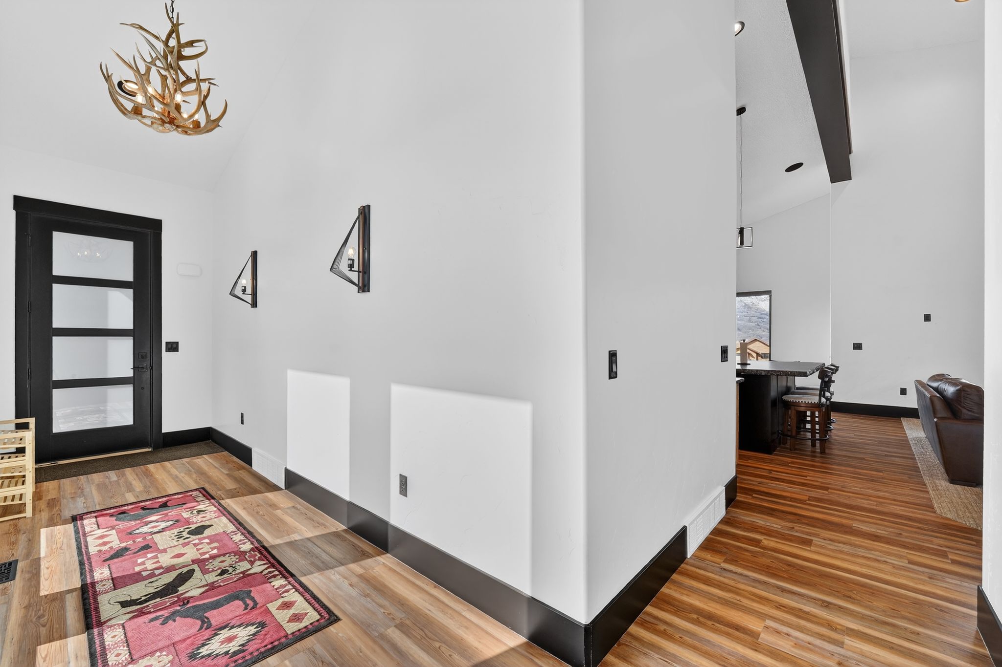 Entrance foyer with lofted ceiling and wood finished floors
