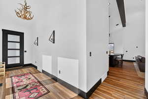Entrance foyer with lofted ceiling and wood finished floors