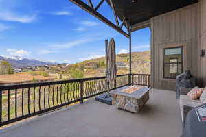Balcony featuring an outdoor fire pit and a mountain view