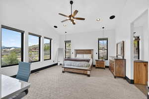 Bedroom with light colored carpet, a ceiling fan, recessed lighting, lofted ceiling, and a mountain view