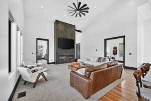 Living room with a fireplace, recessed lighting, lofted ceiling, and a ceiling fan