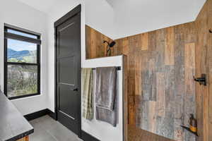 Bathroom with walk in shower, tile patterned floors, and a mountain view