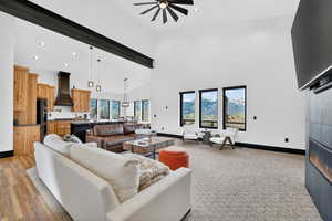 Living room with recessed lighting, ceiling fan, and a high ceiling