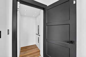 Detailed view of wood finished floors and recessed lighting