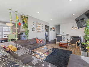 Living room with wood finished floors and a chandelier