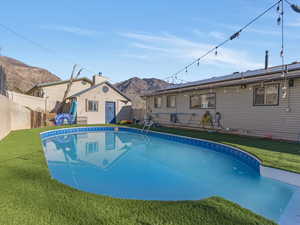 View of pool featuring a mountain view and a fenced backyard
