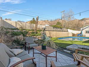 Fenced backyard featuring a patio