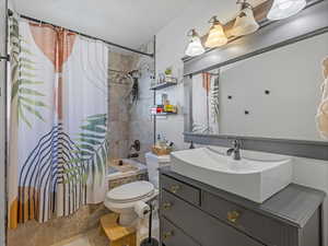 Bathroom with vanity and shower / bath combination with curtain