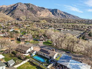 Aerial view of residential area with a mountainous background and a pool
