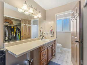 Full bath featuring vanity and light tile patterned floors