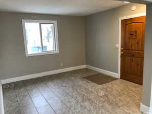 Foyer entrance with baseboards