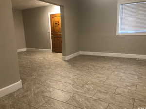 Empty room featuring baseboards