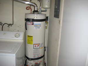 Utilities featuring washer / dryer, water heater, and electric panel