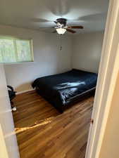 Bedroom featuring dark wood-style floors and a ceiling fan