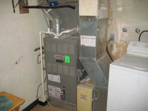Utility room featuring washer / clothes dryer and heating unit