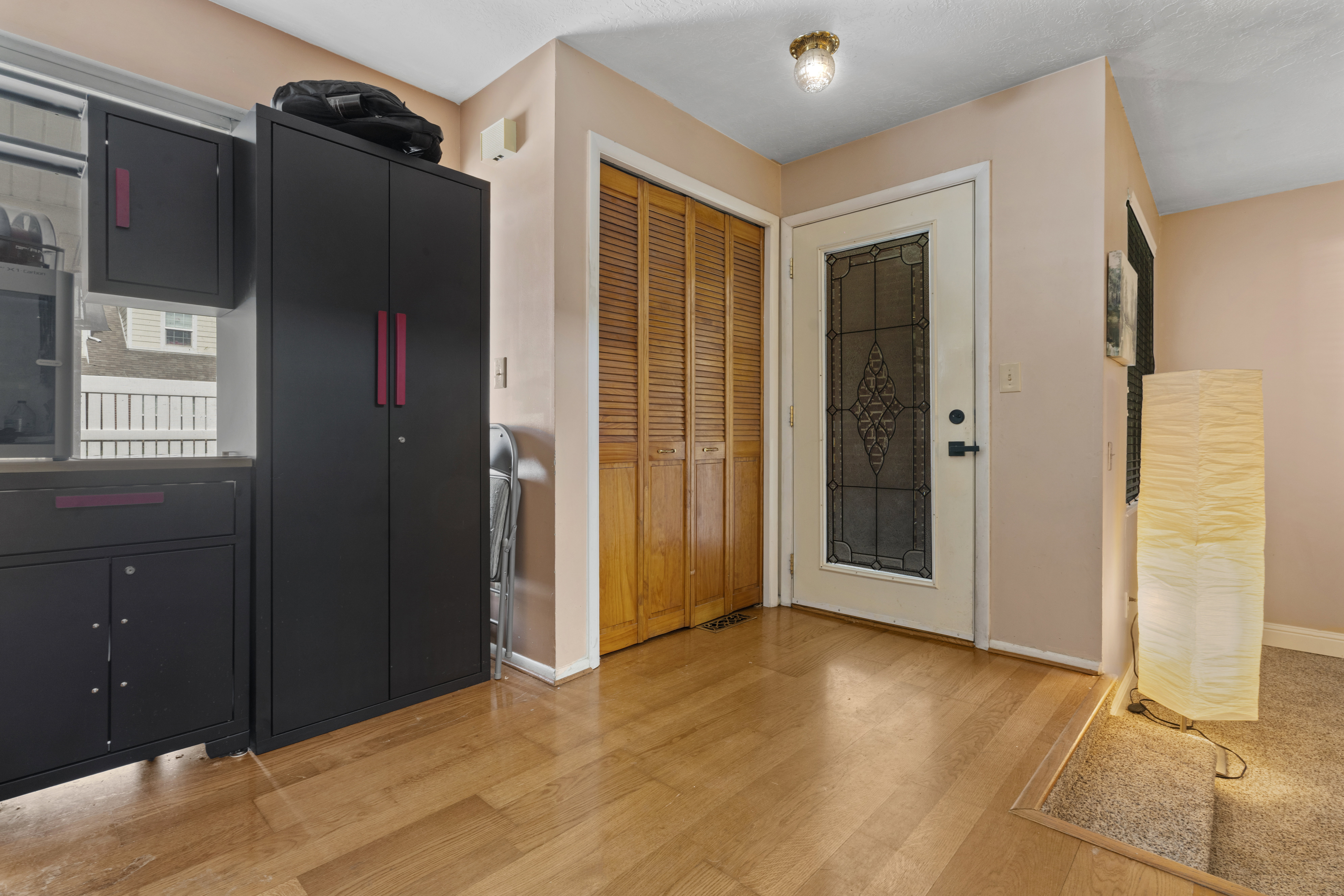 Kitchen with dark cabinets and light wood-style flooring