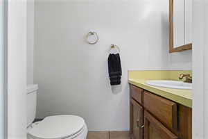 Half bath with vanity and light tile patterned floors