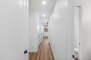 Hallway featuring recessed lighting and light wood-style floors