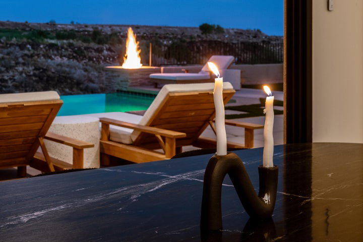 View of swimming pool with an outdoor fire pit and patio surround