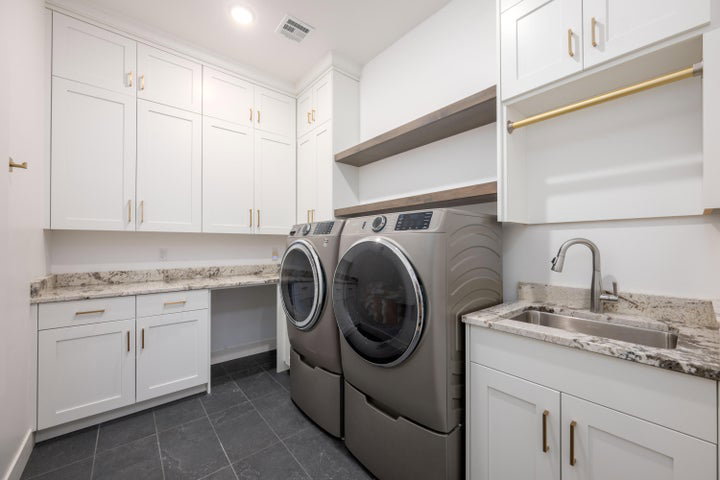 Laundry room with cabinet space, washing machine and dryer, and recessed lighting