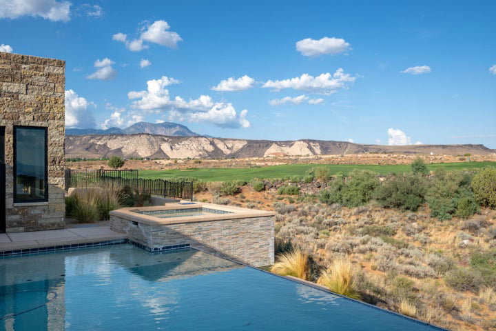 Integrated pool / spa featuring a patio and a mountain view