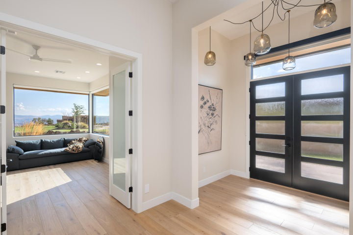 Entryway featuring french doors, light wood finished floors, a ceiling fan, and recessed lighting