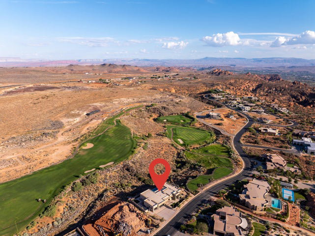 Bird's eye view of a mountain backdrop and a local golf course