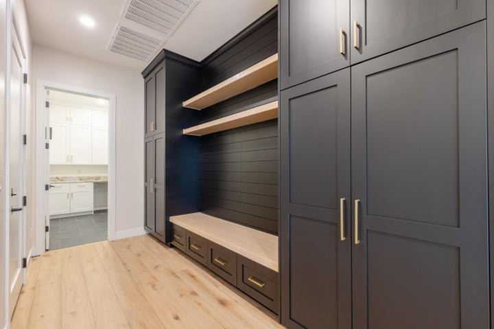 Mudroom featuring light wood-type flooring and baseboards