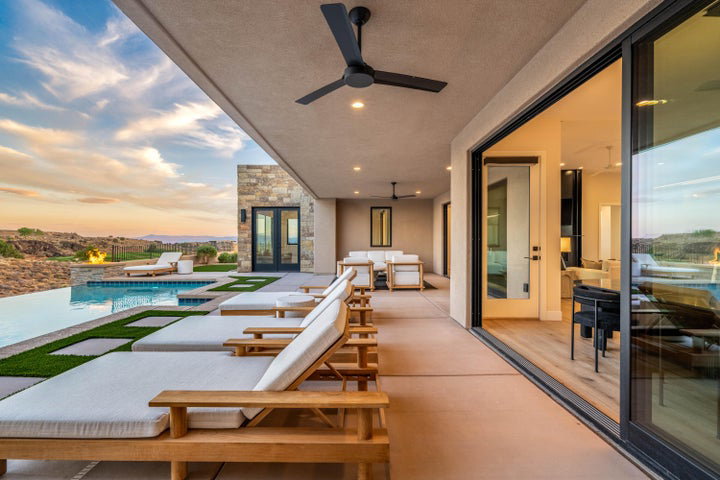 Balcony with view of pool area, a ceiling fan, and an outdoor hangout area