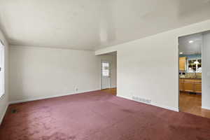 Empty room featuring light colored carpet and recessed lighting