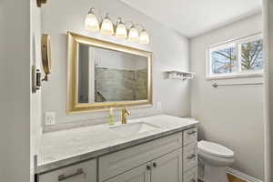 Full bath with vanity and a shower