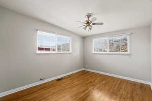 Empty room with wood-type flooring and a ceiling fan