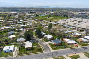 Aerial overview of property's location with mountains and nearby suburban area