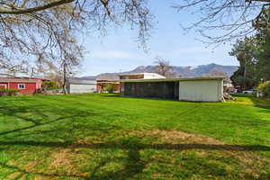 View of grassy yard featuring a mountain view